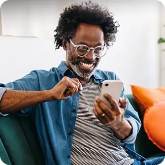A photo of a man looking at his cell phone.