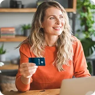 A photo of a woman holding her debit card.