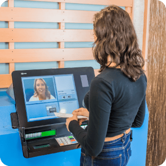 Woman using a video teller machine.