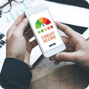 Hands holding a cell phone with a credit score on it.
