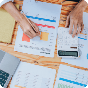 Desk with documents and a calculator on it.