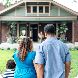 Happy family looking at their new home.