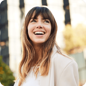 A smiling woman looking off to the distance.