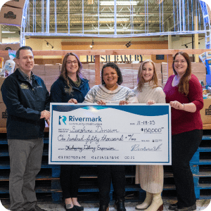 Sunshine Division group of people holding a check.