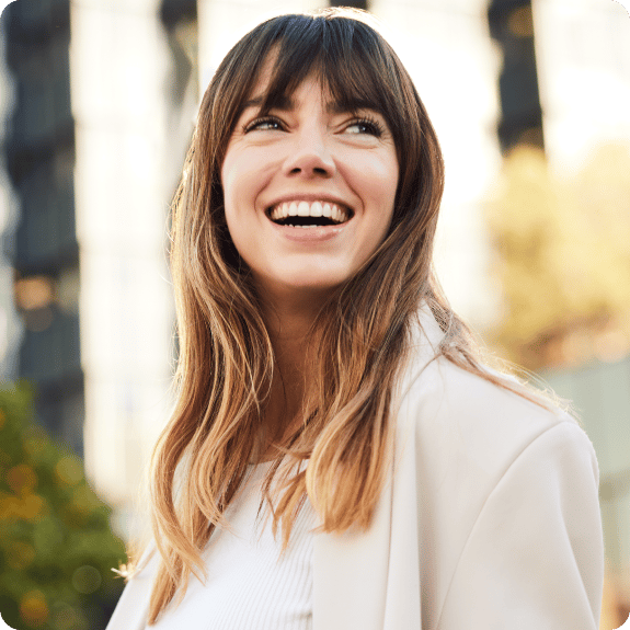 A woman smiling and looking up.