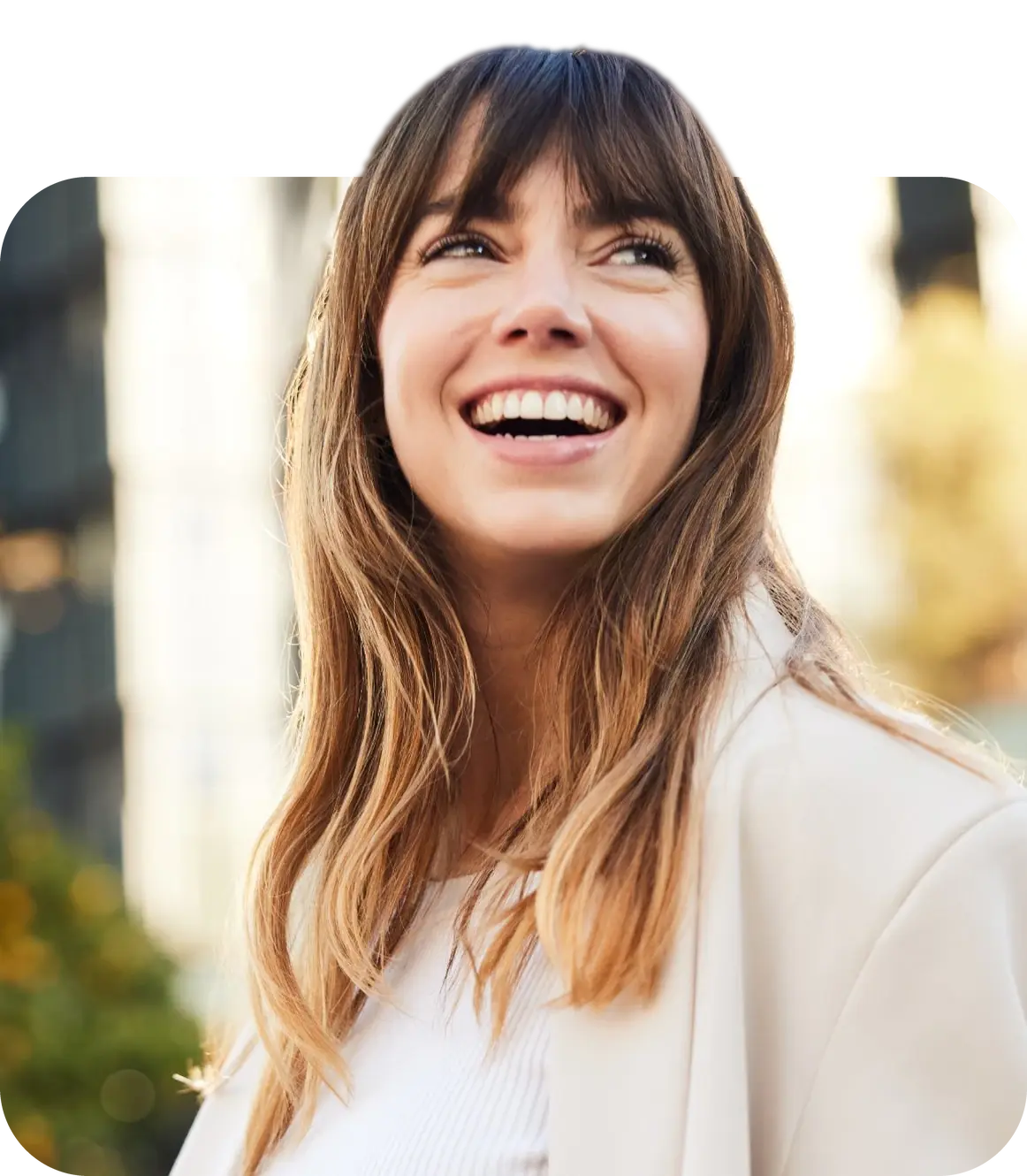 A woman smiling and looking up.