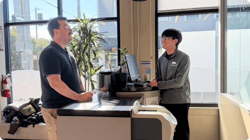 A Rivermark employee is helping a customer in a branch.