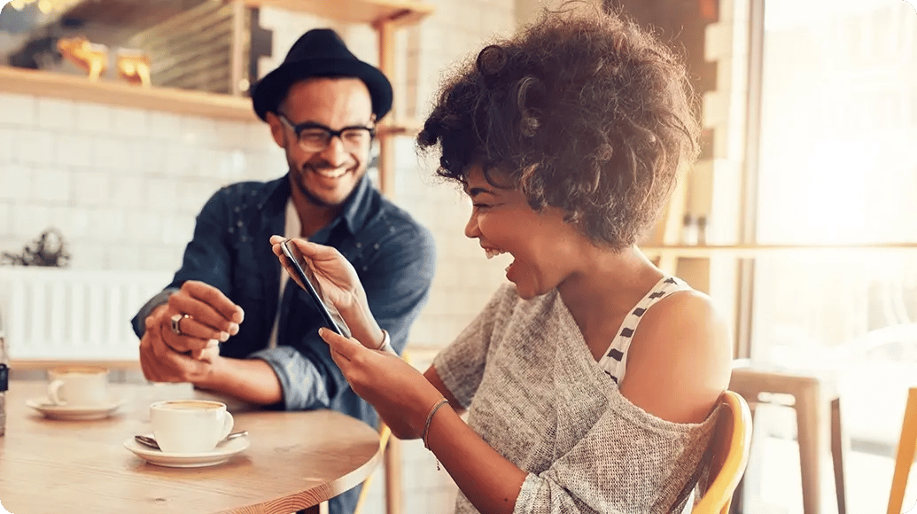 A couple sharing a phone together.