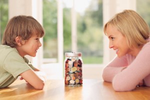 Mom and son with jar of coins