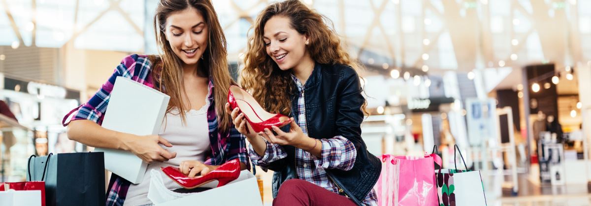 Two women shopping for shoes.