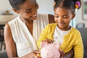 parent and child with piggy bank