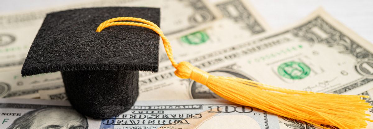 Graduation cap on cash.