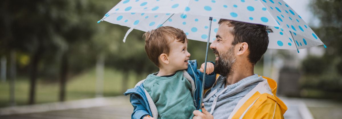 Dad and his son in the rain.