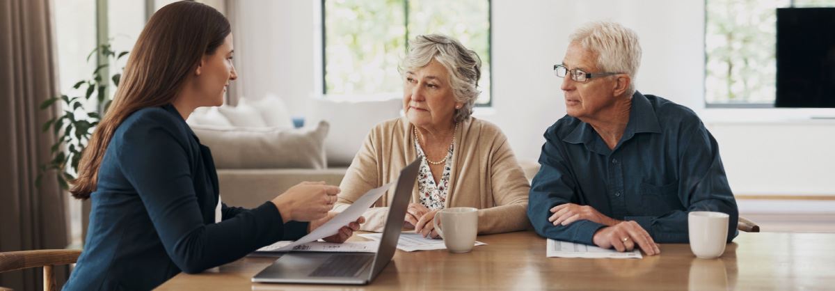 Older couple working with financial advisor. 