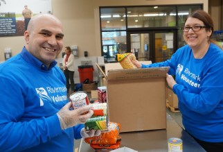 Two Rivermark employees volunteering at the Oregon Food Bank.