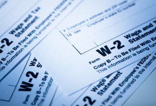 A stack of W-2 tax forms.